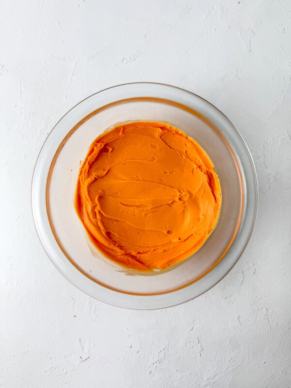 piping the orange frosting 