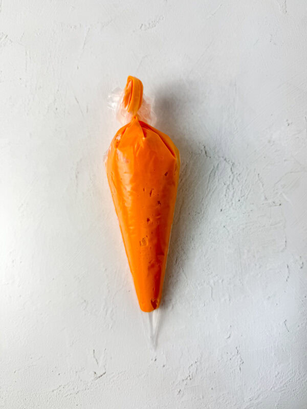 piping the orange frosting 
