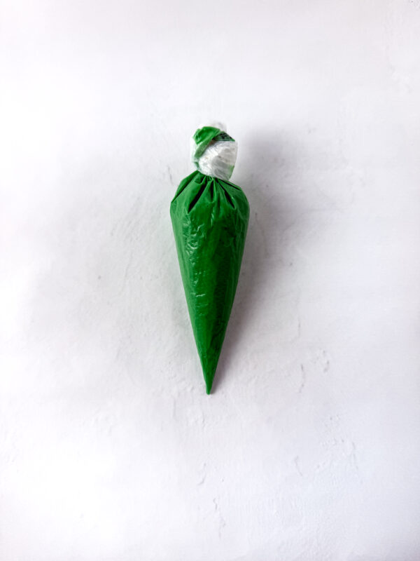 bag of melted wiltons green chocolate wafers for piping