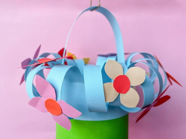 Front view of the paper basket, highlighting the handle and floral decorations