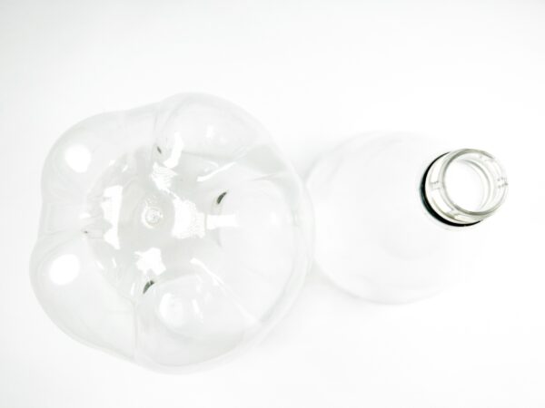 Close-up of the bottle's bottom and neck after being cut apart.
