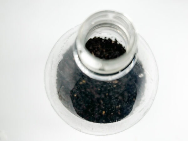 Top view of the soil inside the bottle after watering