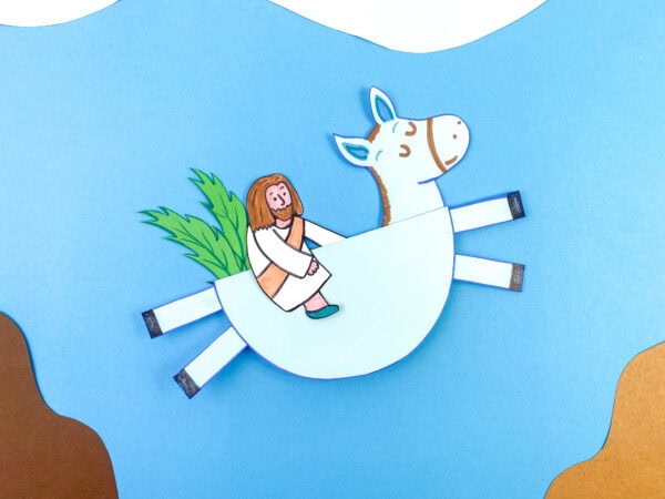 A completed 3D paper donkey craft with a cutout of Jesus sitting on it