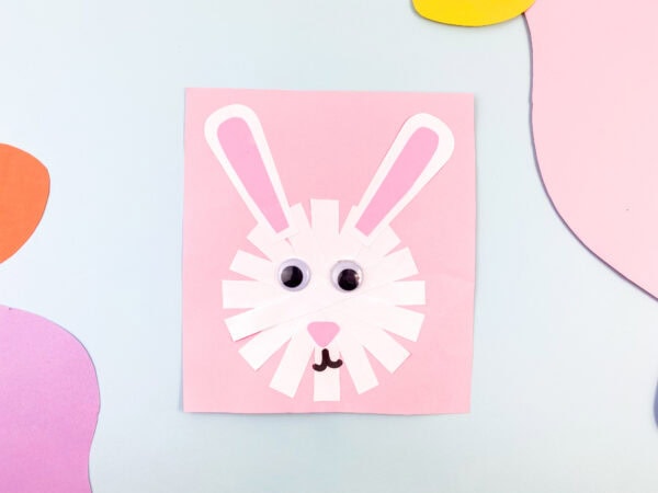 The completed bunny craft on a pastel background.