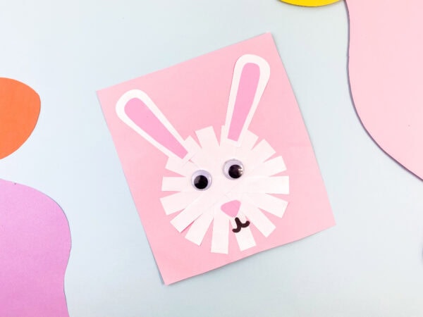 The completed bunny craft on a pastel background.