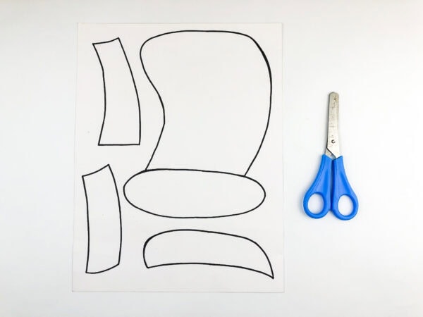 hat template on white paper and scissors beside it