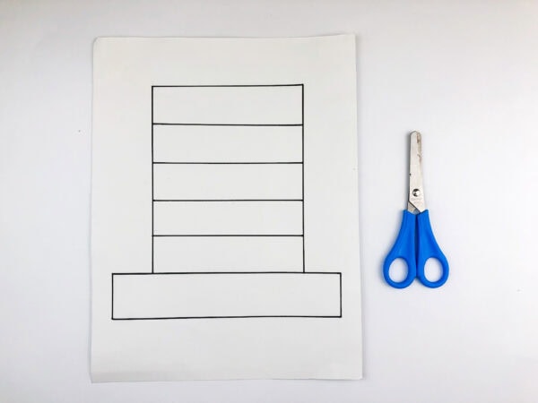 Hat outline on white paper with scissors