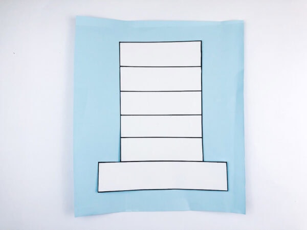 Hat outline glued to blue paper