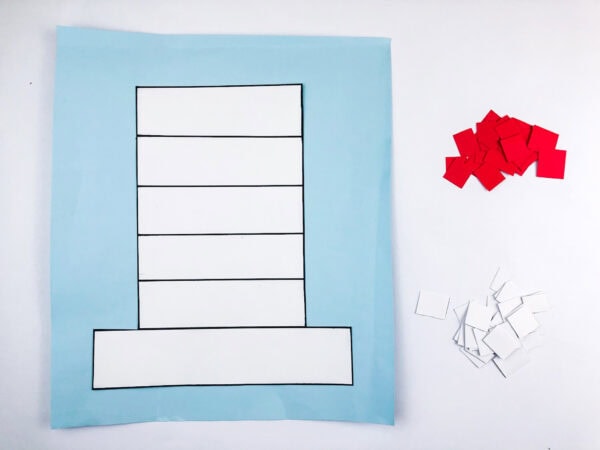Hat outline on blue paper with red and white squares nearby