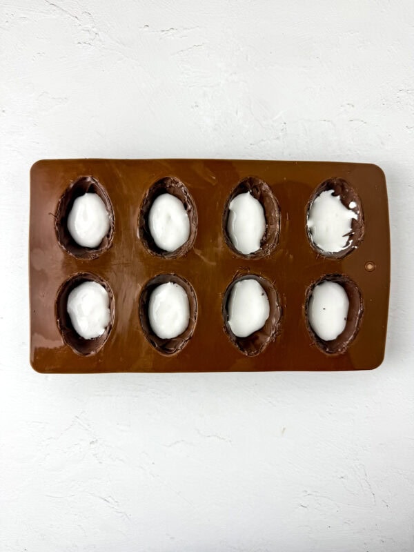 Chocolate egg molds filled with marshmallow fluff.