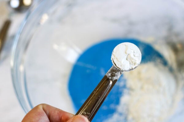 A close-up of a teaspoon filled with cornstarch