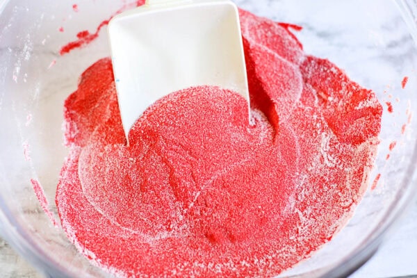 The red sand and cornstarch being stirred together