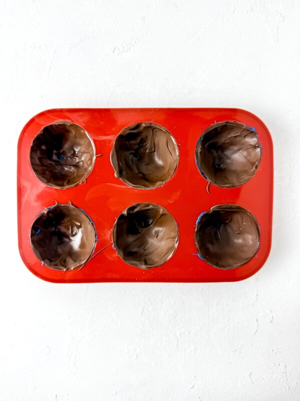 Silicone mold filled with chocolate covering the bottom layer.