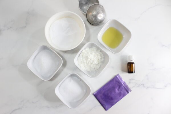 DIY bath bomb ingredients in small bowls.
