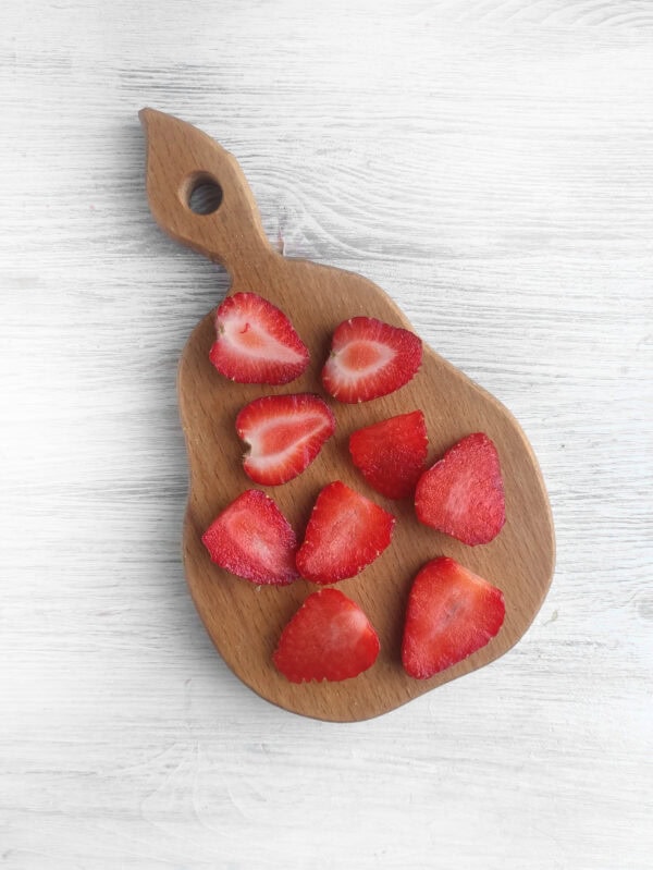 cutting up strawberries for the charcuterie fruit tree