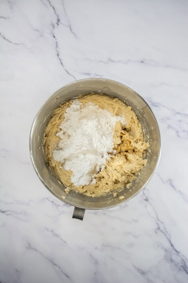 Mixing bowl with powdered sugar and frosting mixture.