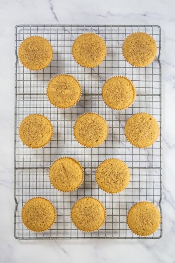 Baked espresso cupcakes cooling on a wire rack.