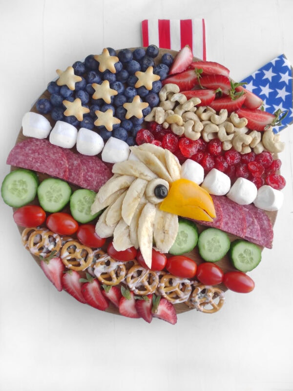 Decorated patriotic charcuterie board with an eagle and added American flag elements.