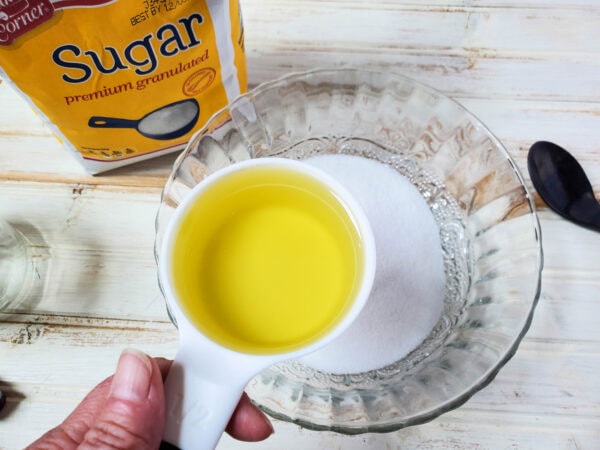 Adding oil to sugar for scrub mixture