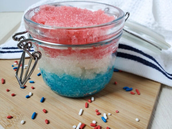 Patriotic sugar scrub in jar with scattered sprinkles