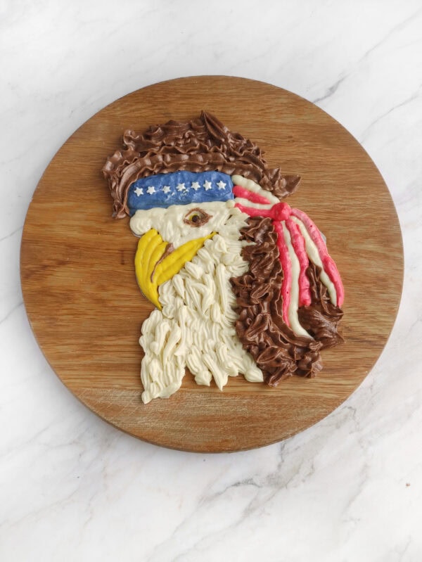 Eagle frosting design completed on wooden board.