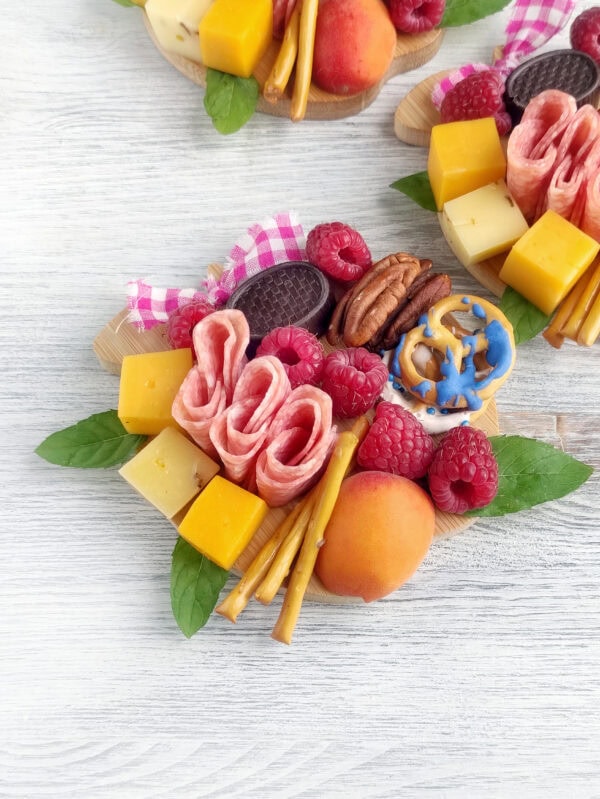 Zoomed-in view of two assembled mini charcuterie boards with visible ingredients.