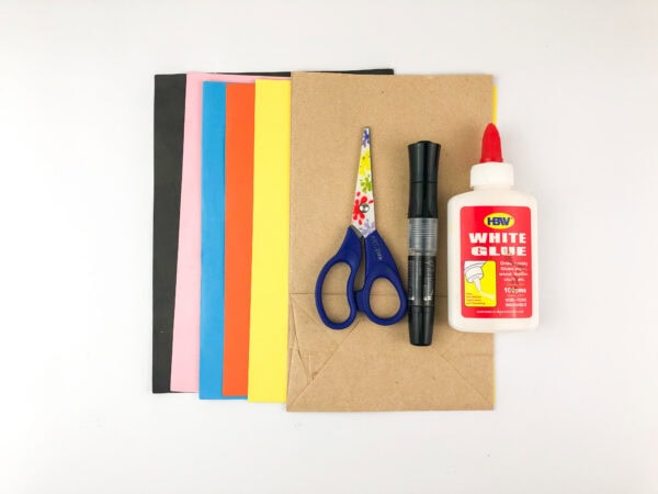 Craft materials including colored paper, scissors, glue, and markers