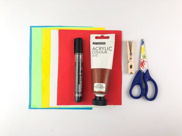 Craft supplies including paper, paint, clothespin, marker, and scissors