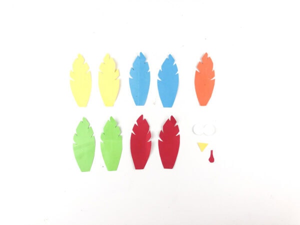 Cut-out paper feathers and face pieces for turkey craft.