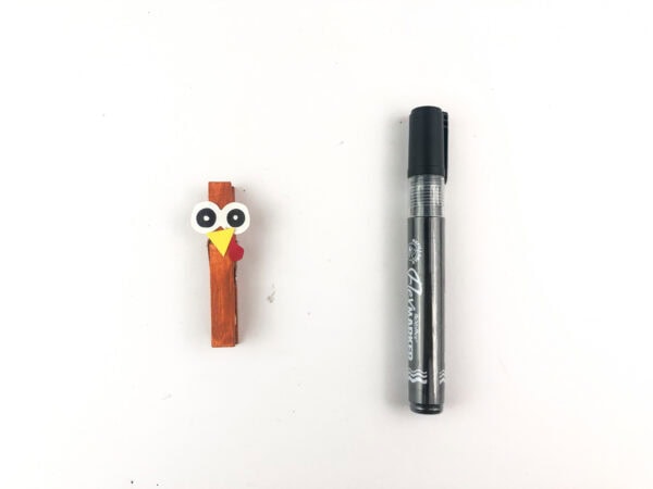 Turkey face on clothespin with marker beside it.
