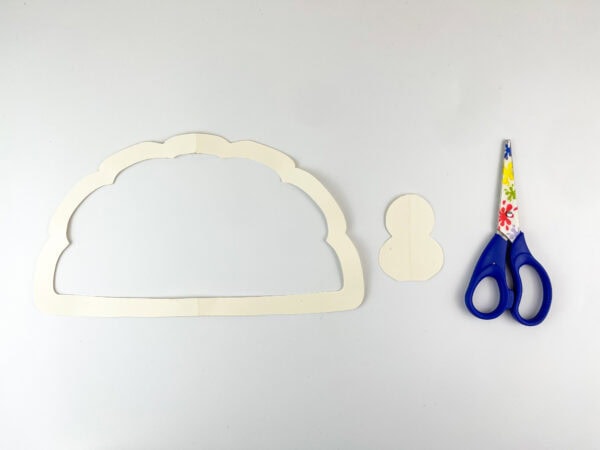 White paper pieces cut into shapes with scissors.
