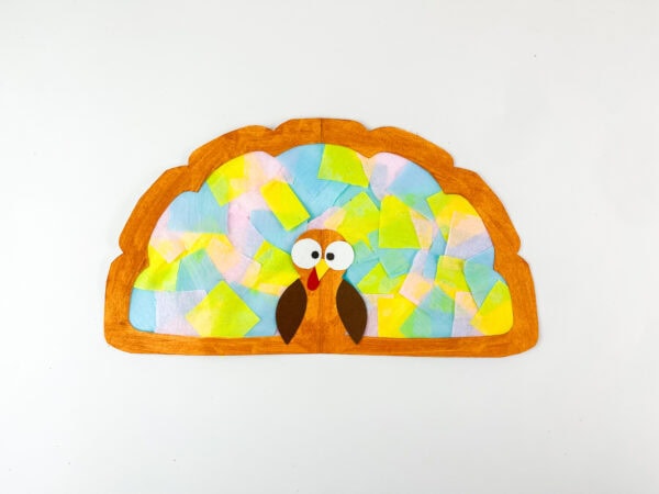 Completed turkey craft with decorated feathers.