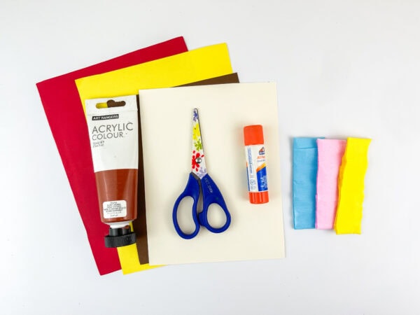 Craft supplies including paper, paint, glue, scissors, and tissue paper.