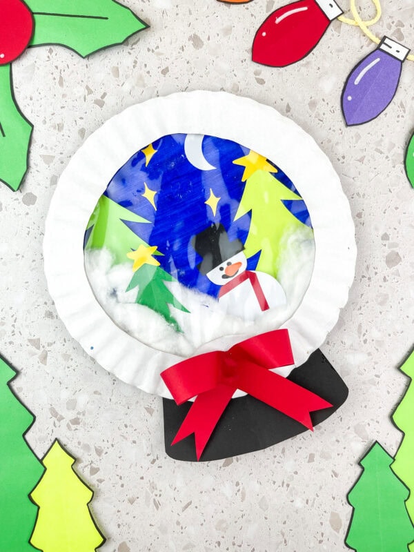 Finished snow globe craft with bow and holiday decorations
