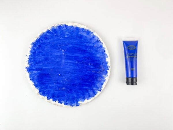 Paper plate painted blue for snow globe craft