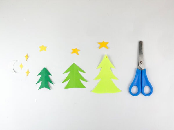 Cut-out stars, moon, and trees for snow globe craft