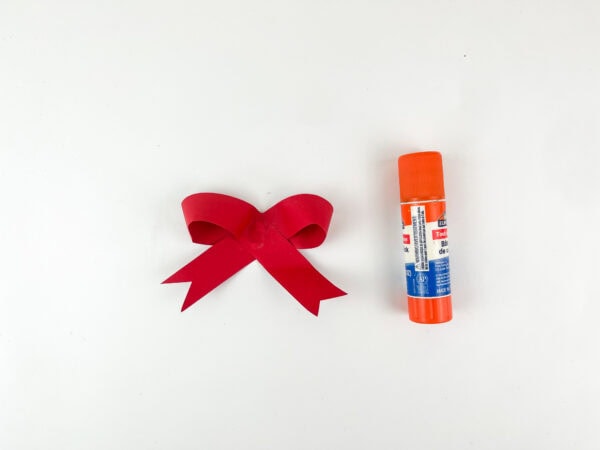 Red paper bow and glue stick
