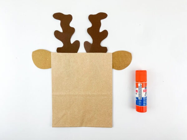 Paper bag with antlers and ears glued on top
