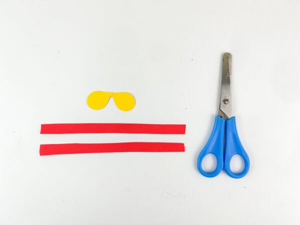 Cut-out red strips and yellow bow shape with scissors
