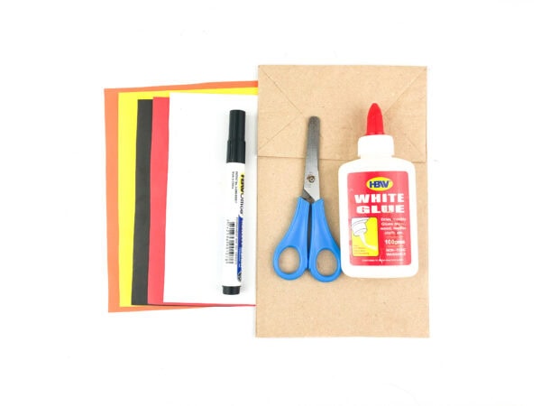 Craft supplies including glue, scissors, marker, paper, and paper bag