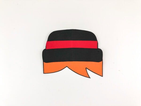 Assembled black hat with red band and orange hair.