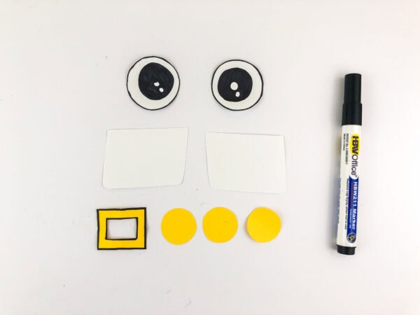 Drawn eyes, rectangles, circles, and buckle cutouts with marker.