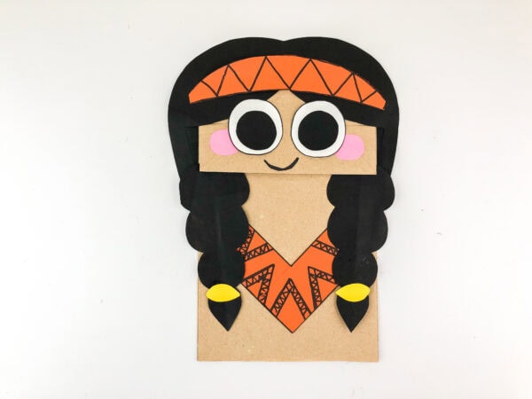 Paper bag puppet with added headband and smile.