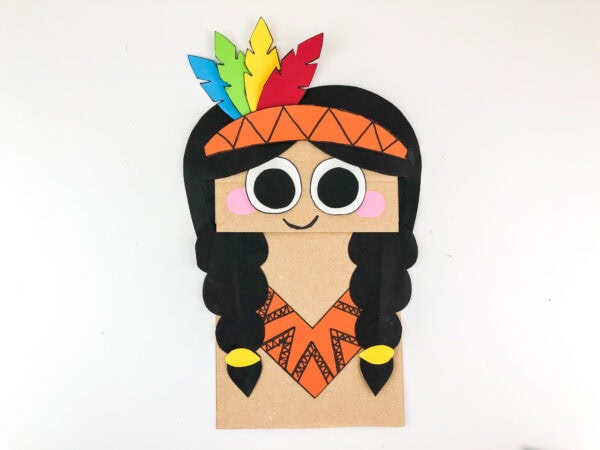 Finished Native Indian girl paper bag puppet with colorful feathers.