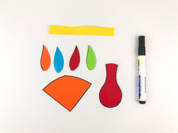 Cut-out craft pieces for pilgrim turkey, including beak, feathers, and wattle.