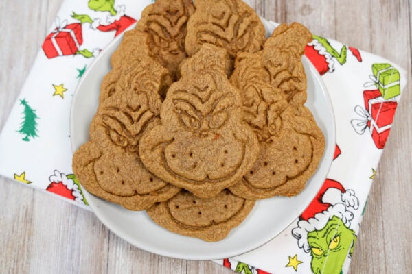 Top view of Grinch cookies on a plate with Christmas napkin