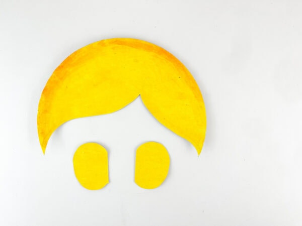 Yellow paper cutouts shaped like hair and side buns.