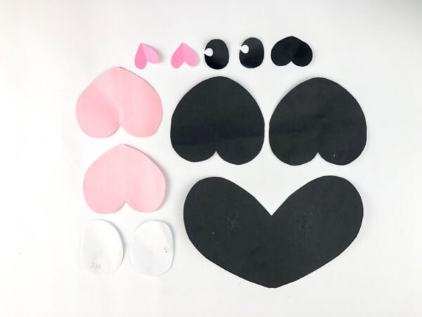 Paper shapes for panda craft arranged by color and size.