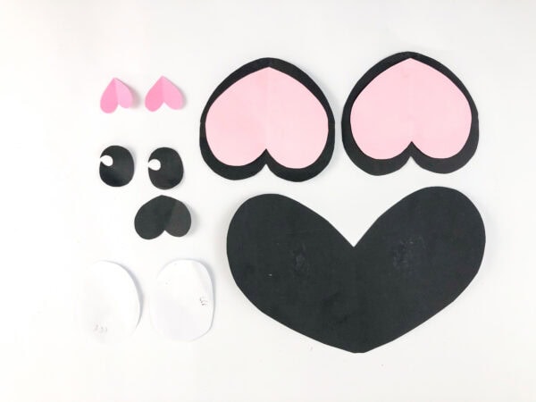 Pink, black, and white cut-out shapes for panda ears and face.