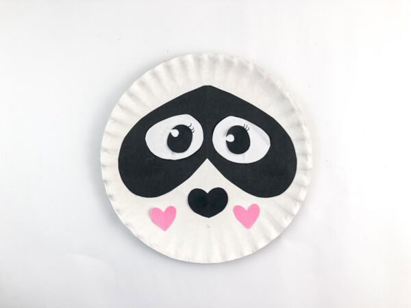 Paper plate panda face with added pink cheek hearts.

